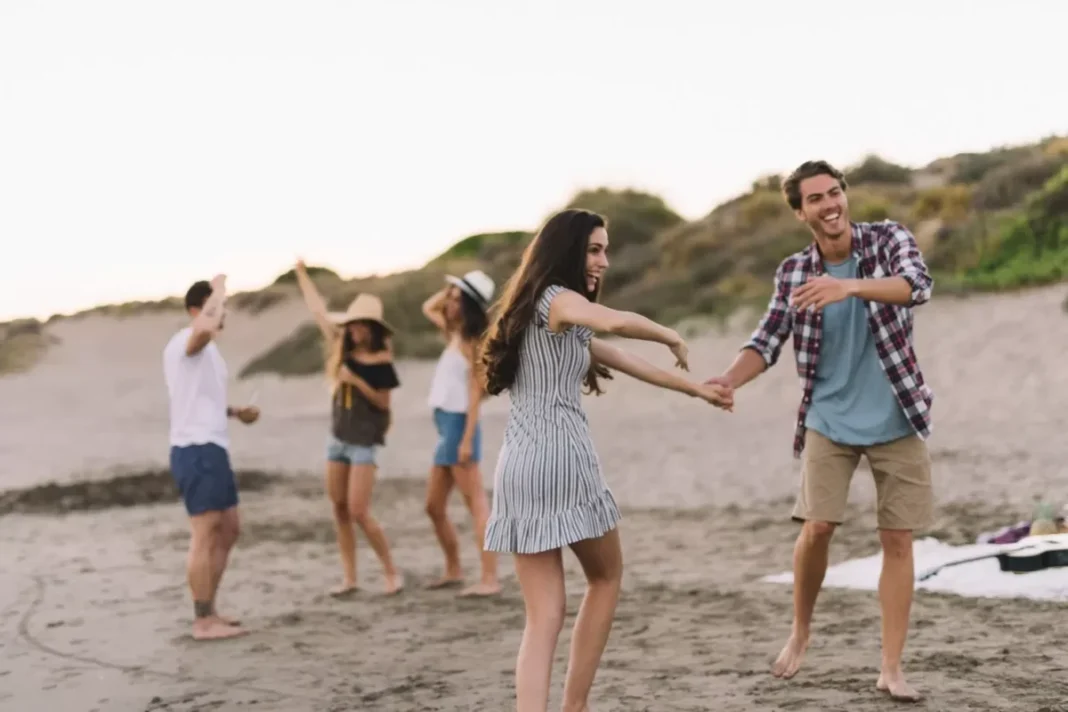 group-friends-dancing-beach_23-2147643705-1477386894